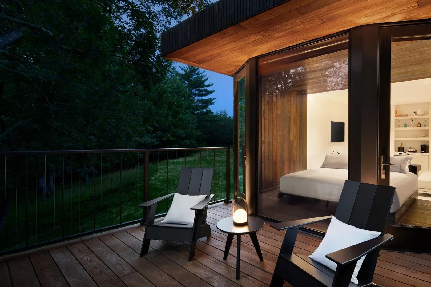 The deck at dusk, door open to the bedroom